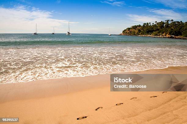 Footsteps In The Sand On A Beach Stock Photo - Download Image Now - Absence, Beach, Blue