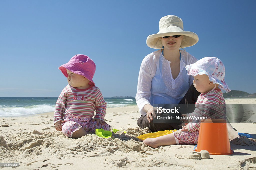 Matka i dzieci na plaży Twin - Zbiór zdjęć royalty-free (Słońce)