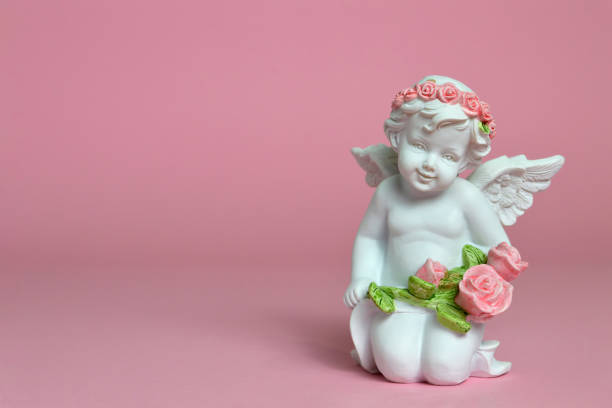 istock Angel holding flowers 983958154