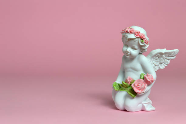 istock Angel guardian holding flowers 983958388