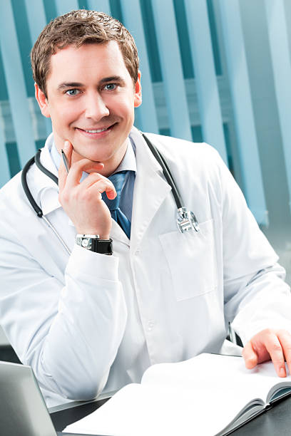 istock Happy smiling doctor with pen at office 98397028