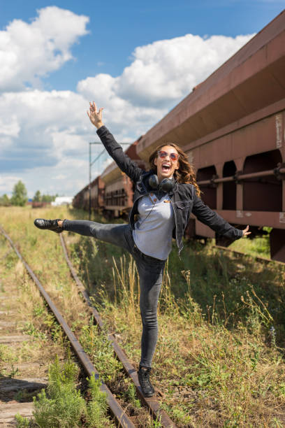 Beautiful young girl fooling around on rails