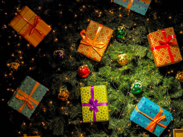 istock Christmas gift box. presents in front of a festive background. 983974256
