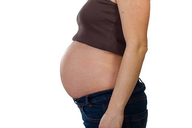 Young pregnant woman with big belly stock photo