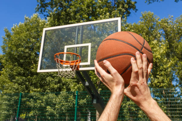 istock hands throwing basketball ball 984003308