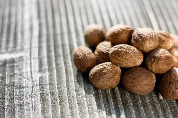 istock aromatic nutmeg on a gray wooden background 984003580