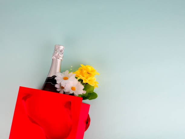 istock flowers in the package on blue background, space for text 984003646