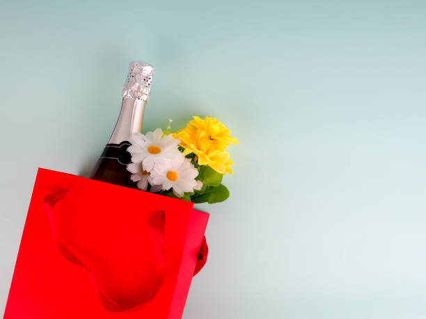 istock flowers in the package on blue background, space for text 984003650