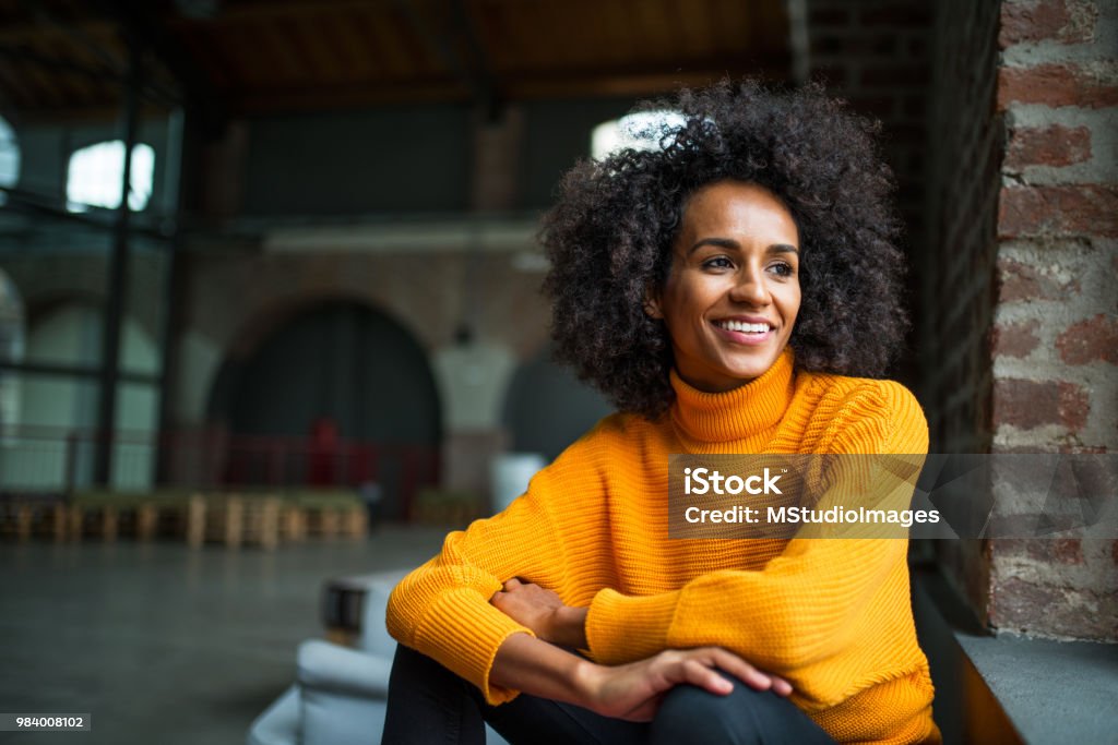 Portrait of smiling African American woman Portrait of smiling African American woman looking trow the window Women Stock Photo