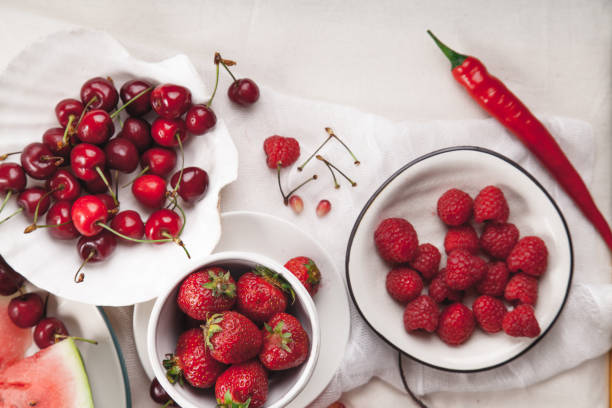 istock Red fruit and vegetable composition on linen fabric. Summer natural beauty concept with copy space. 984011454
