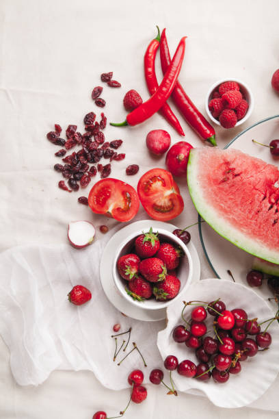 istock Red fruit and vegetable composition on linen fabric. Summer natural beauty concept with copy space. 984011528