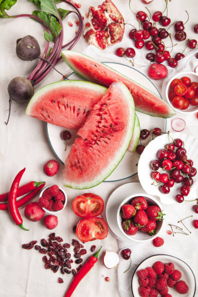 istock Red fruit and vegetable composition on linen fabric. Summer natural beauty concept with copy space. Vertical composition 984011594
