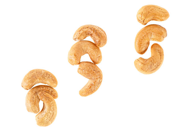 istock Roasted and salted cashew nuts isolated on white background, top view. 984016074