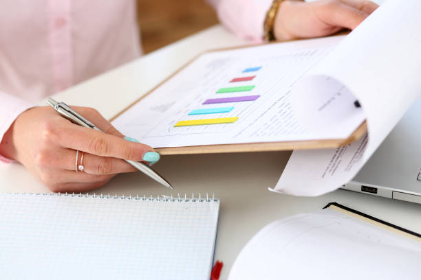 istock Female hands hold silver pen and pad 984018958