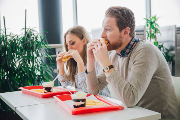 istock Young couple eating junk food 984023088