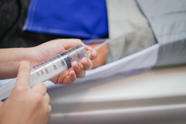 Radiologist to inject contrast media into the patient before CT scan.