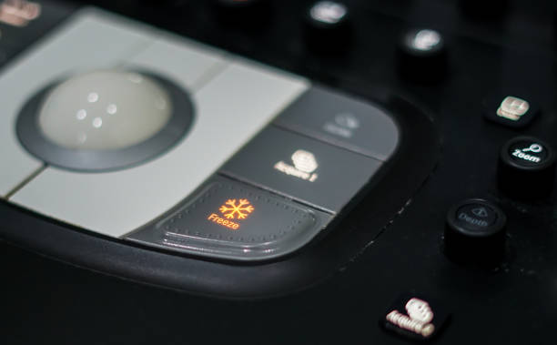 istock Doctor hand pressing on control panel button of ultrasound machine 984024156