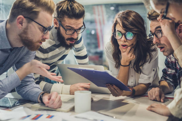 istock Team of nerdy entrepreneurs reading shocking reports in the office. 984029320