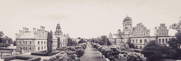 Chernivtsi city, Bukovina, Ukraine - June 12, 2018: building of the Residence of Metropolitan Bukovina and Dalmatia and the National University named after Yuri Fedkovych in the city of Chernivtsi, Ukraine. A historic building from the 19th century and UNESCO World Heritage Site. Tourist attraction of Ukraine and Eastern Europe. Christian cathedral against the backdrop of a summer garden