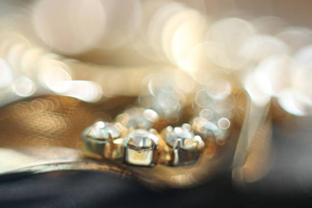 Golden jewelry with white crystal stones in macro mode