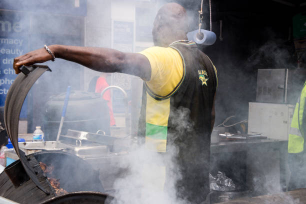 Jamaican chef cooking jerk chicken - Food Street Market Reading, UK - June 2nd, 2018
