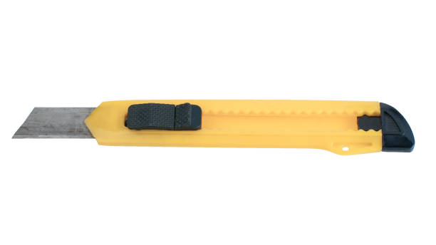 istock Yellow box cutter knife isolated on white background closeup 984036744