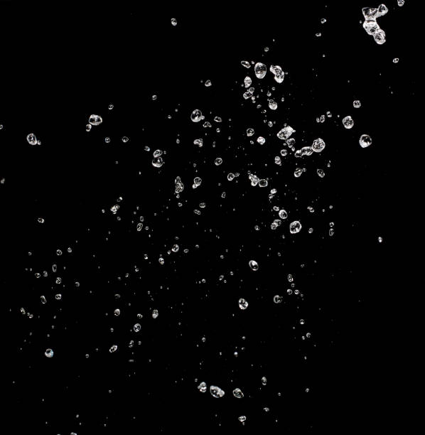 water splash isolated on black background - water splashing spray drop imagens e fotografias de stock