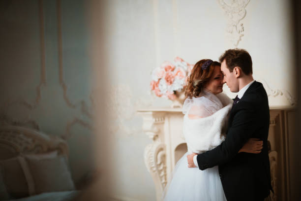istock young bride and groom couple in a bright studio photo 984050040