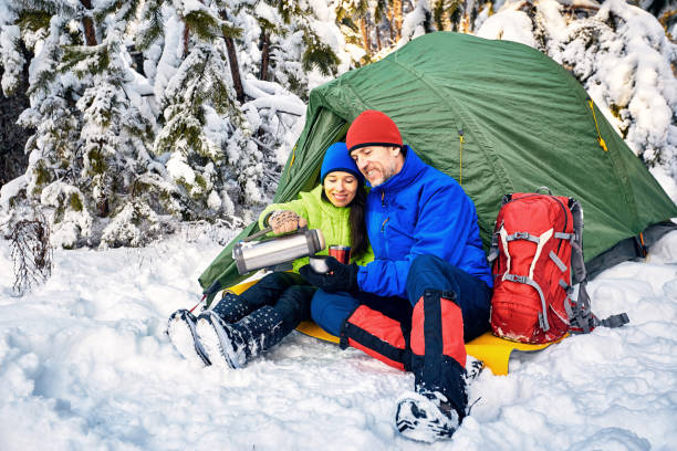 istock Walk through the winter forest with a backpack and tent. 984050356
