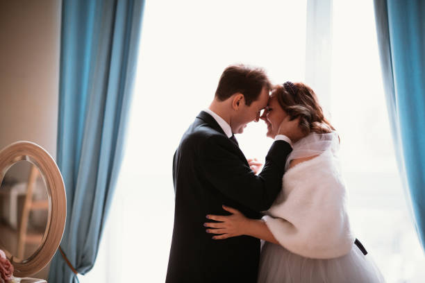istock young bride and groom couple in a bright studio photo 984053278
