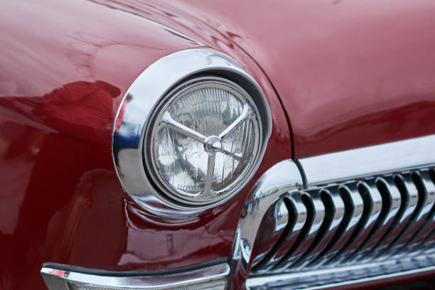 istock The front lights of an old red car 984053516