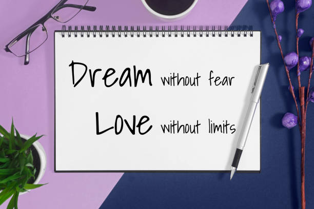 istock Notebook with quote on pastel purple and blue background. 984057346