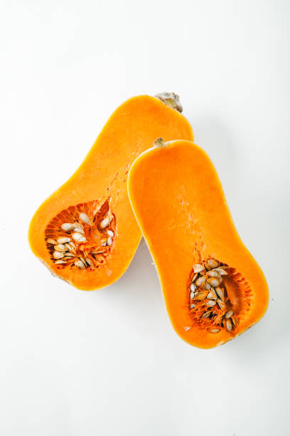 istock Butternut squash halved on white background with copy space. Organic food concept. 984057754