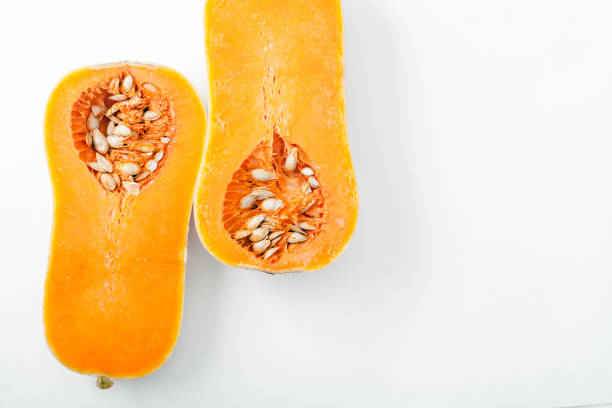 istock Butternut squash halved on white background with copy space. Organic food concept. 984057784