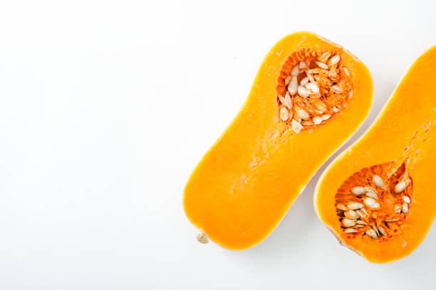 istock Butternut squash halved on white background with copy space. Organic food concept. 984057794