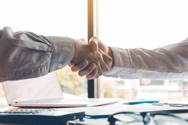 istock Business people accept or confirm project on the proposal and join shaking hands at office. 984069864
