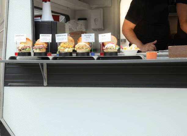 istock Food truck owner serving burger 984071408