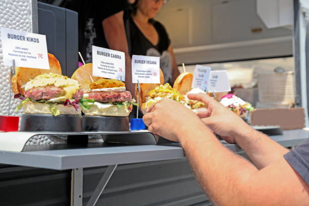 istock Food truck owner serving burger 984071410