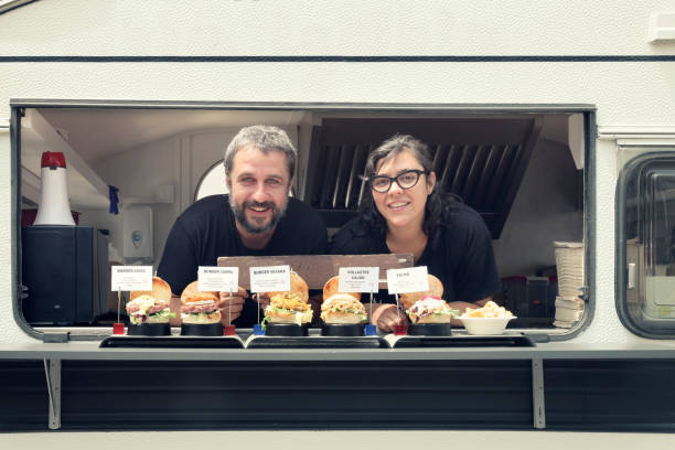 istock Food truck owner serving burger 984071414