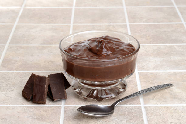 chocolate pudding with pieces of chocolate chocolate pudding with pieces of chocolate and a spoon custard stock pictures, royalty-free photos & images