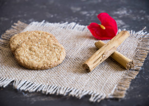 istock cinnamon stick and cakes and red flower 984079580