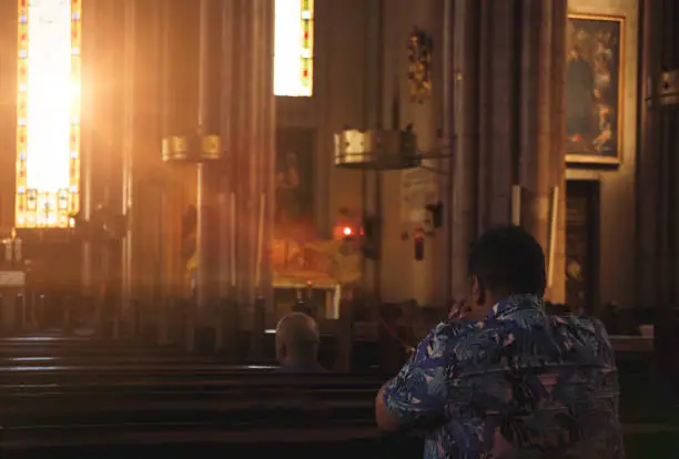 Man Praying in Church
