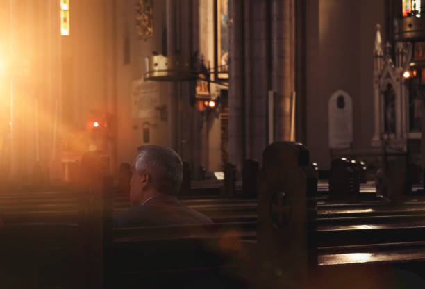 istock Man Praying in Church 984094044