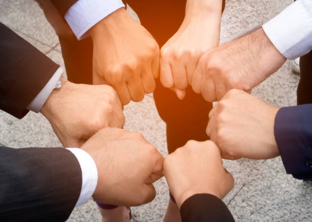 istock teamwork support fist bump after complete deal 984099128