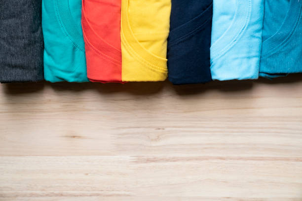 istock close up of rolled colorful clothes on table background 984106424