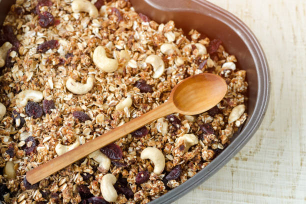 istock Granola on a baking sheet on a light white background. Close up 984112200