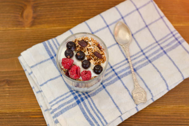 istock Yoghurt with granola and fruit. Healthy breakfast. Top view 984112396
