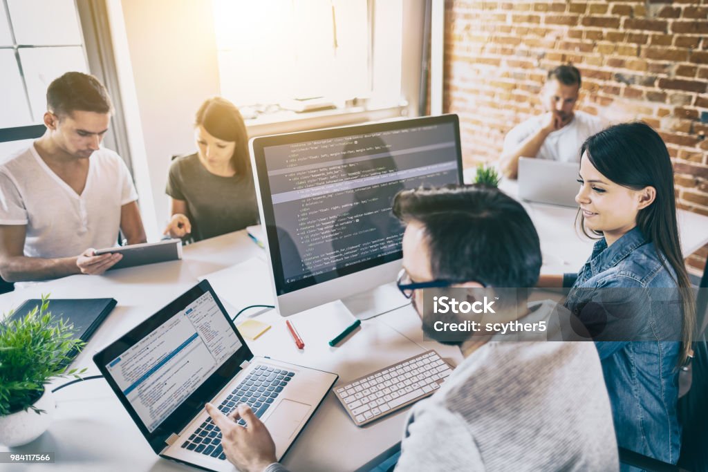 Website design. Developing programming and coding technologies. Developing programming and coding technologies. Website design. Programmer working in a software develop company office. Teamwork Stock Photo