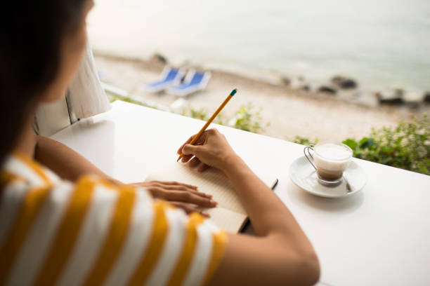 istock Close up of a woman writing. 984119742