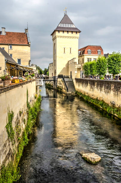 The tower of Geulpoort gate in Valkenburg, The Netherlands reflecting in the river Geul